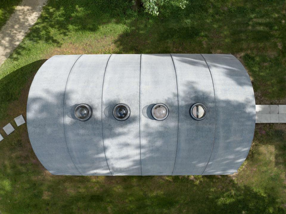 Das Dach des Fertighauses soll aus rollbarem Beton bestehen. Installierte Bullaugenfenster sorgen indes für Tageslicht im Inneraum. Foto: Chiara Becattini____