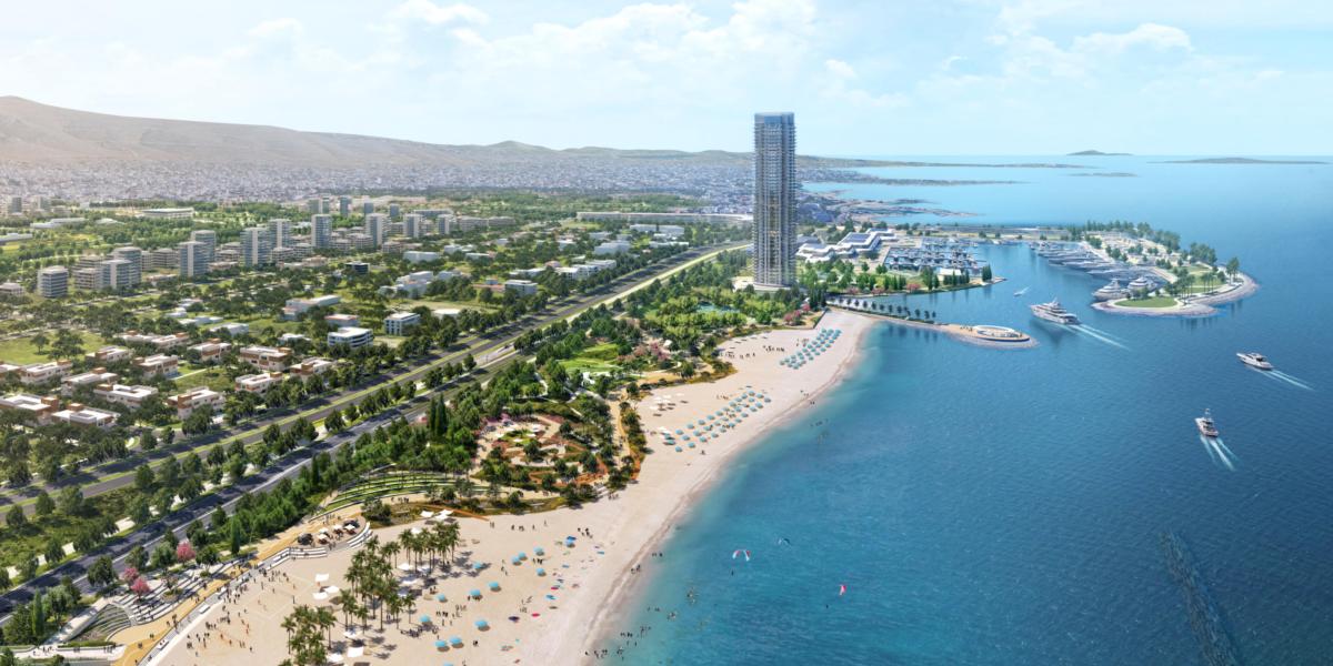 Luftaufnahme eines modernen Küstenresorts mit Sandstrand, Palmen, Yachthafen und Hochhaus am türkisblauen Meer.