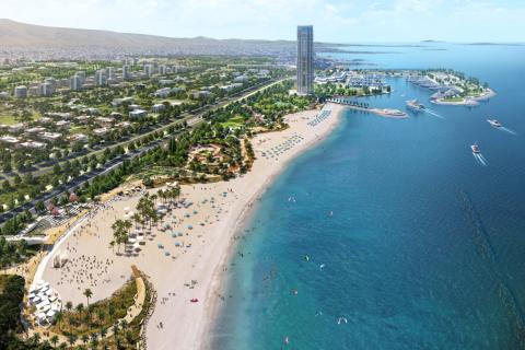 Luftaufnahme eines modernen Küstenresorts mit Sandstrand, Palmen, Yachthafen und Hochhaus am türkisblauen Meer.