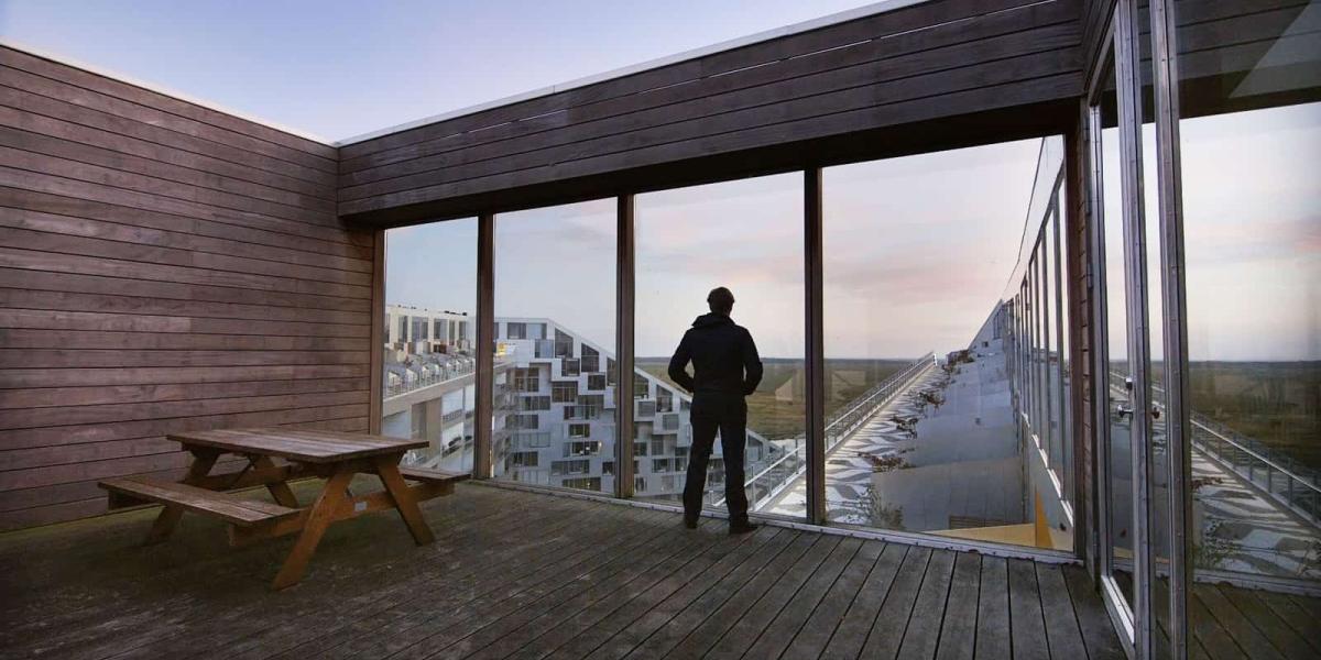 Ein Mann betrachtet von der Dachterrasse eines Hochhauses aus die Umgebung: "The Infinite Happiness" nennen die Künstler diesen Filmauszug © Ila Bêka & Louise Lemoine